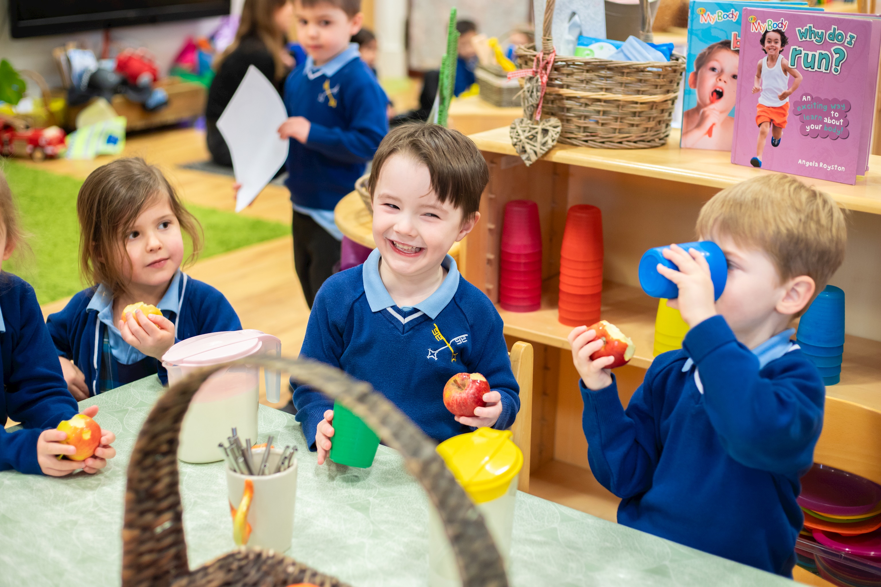 Child eating an apple in nursery